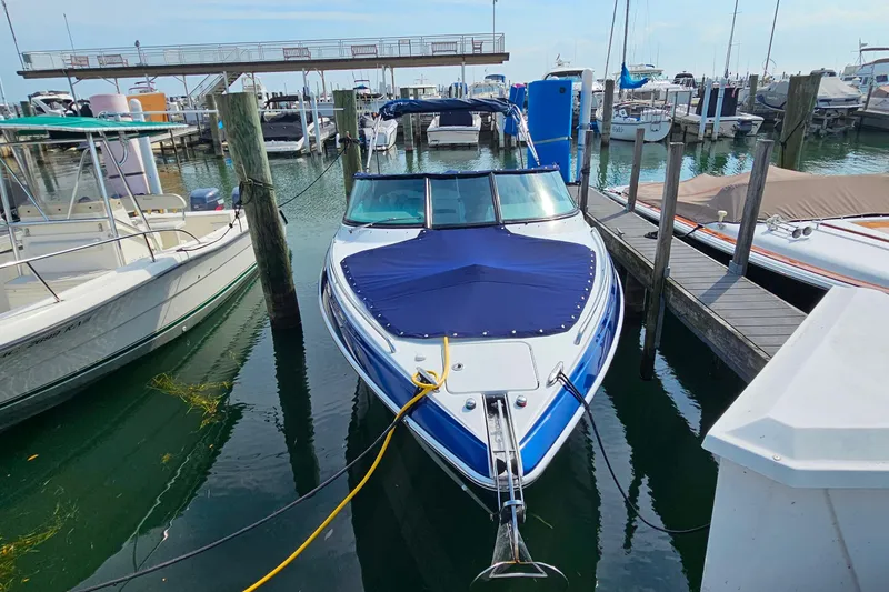 Slide: The Image of 2011 Formula 290 Bowrider docked at marina, covered with blue tarp. - 5