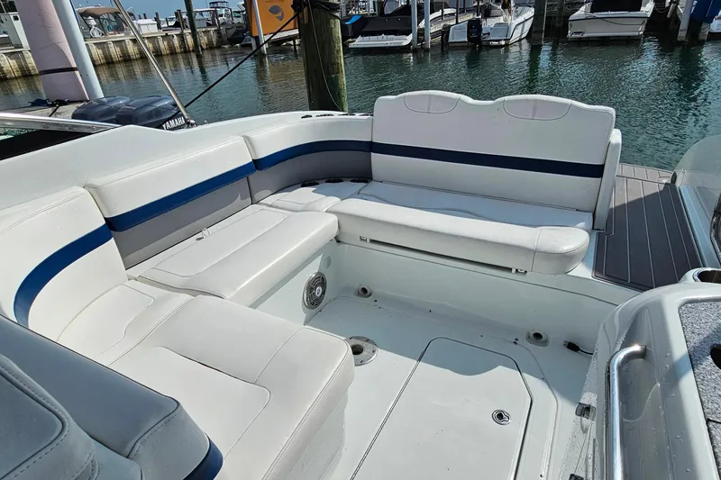 Slide: The Image of 2011 Formula 290 Bowrider interior with white seating, docked at marina. - 9