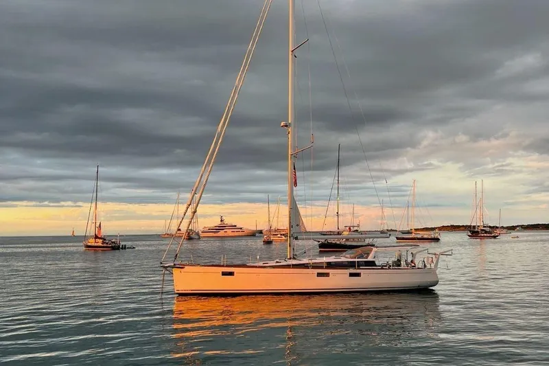 The Image of Sailboats anchored at sunset, featuring a 2017 Beneteau Sense 50. - 0
