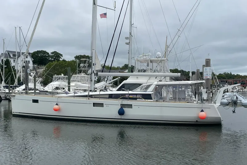 Slide: The Image of 2017 Beneteau Sense 50 sailboat docked in a marina with overcast skies. - 1