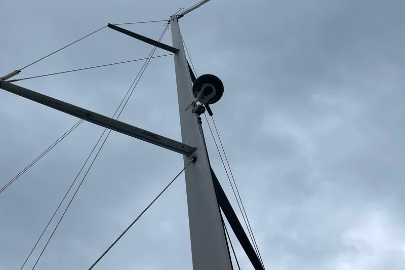 Slide: The Image of Mast of 2017 Beneteau Sense 57 sailboat against cloudy sky. - 100