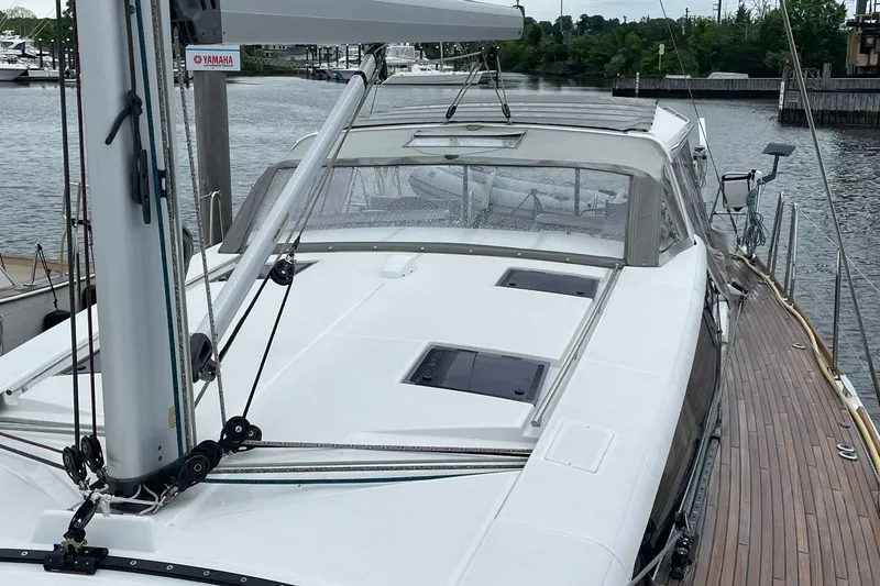 Slide: The Image of 2017 Beneteau Sense 57 yacht docked, showcasing sleek deck design and modern sailing features. - 108