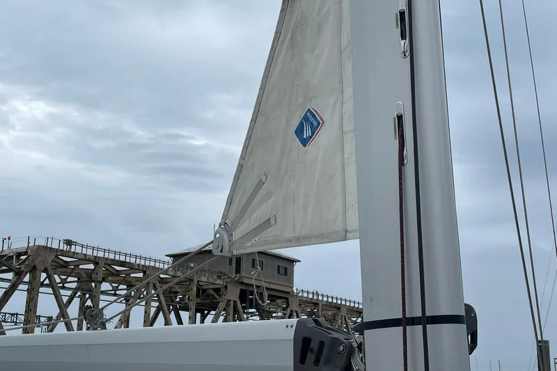 Slide: The Image of Sail of a 2017 Beneteau Sense 57 yacht against a cloudy sky backdrop. - 109