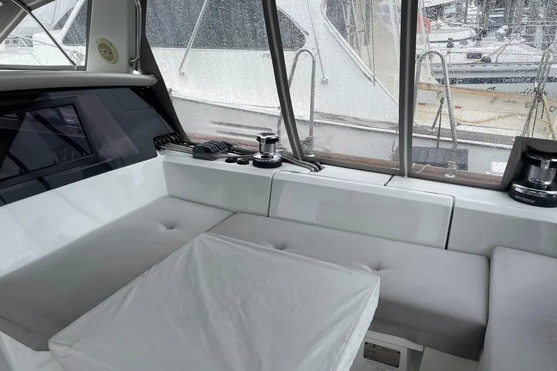 Slide: The Image of Interior of 2017 Beneteau Sense 57 yacht with cushioned seating and winch. - 112