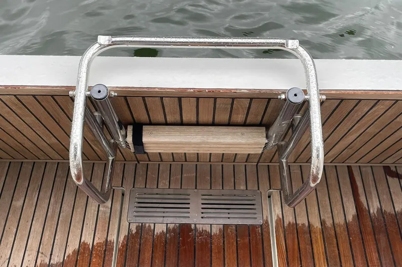 Slide: The Image of Stainless steel swim ladder on 2017 Beneteau Sense 57 yacht with teak decking. - 114