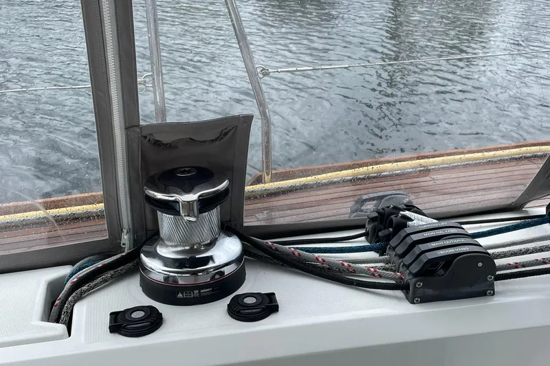 Slide: The Image of Cockpit view of 2017 Beneteau Sense 57 sailboat with winch and control lines. - 115