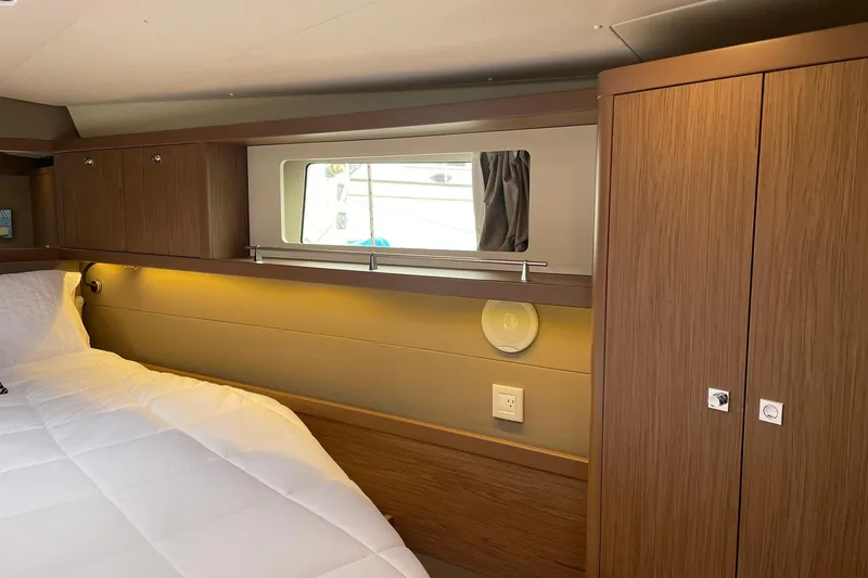 Slide: The Image of Luxurious cabin interior of 2017 Beneteau Sense 57 yacht with wood finish and cozy bedding. - 118