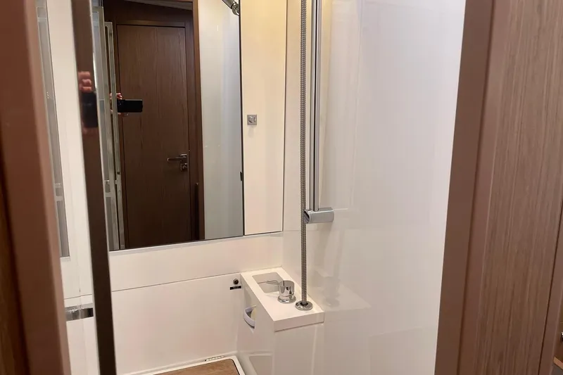Slide: The Image of Modern bathroom interior on a 2017 Beneteau Sense 57 yacht, featuring sleek fixtures and wood accents. - 119