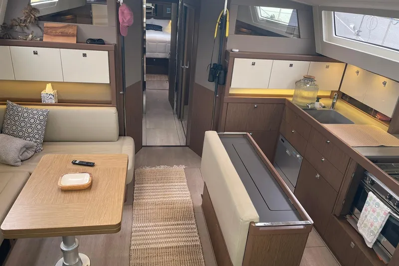 Slide: The Image of Luxurious interior of 2017 Beneteau Sense 57 yacht with modern kitchen and seating area. - 122