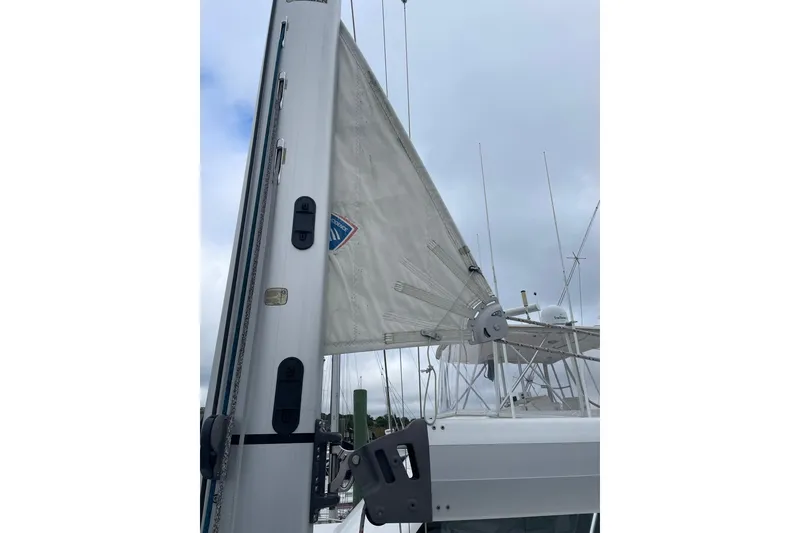 Slide: The Image of 2017 Beneteau Sense 50 sailboat mast and sail against cloudy sky. - 17