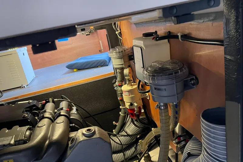 Slide: The Image of Engine room of a 2017 Beneteau Sense 50 yacht, showcasing mechanical components and wiring. - 23