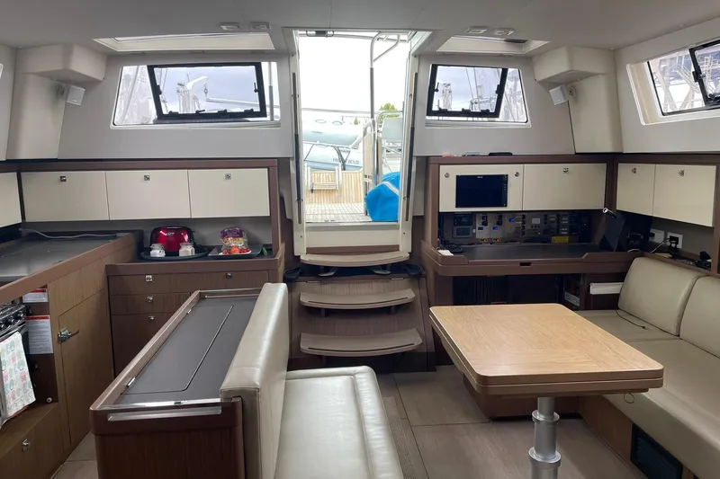 Slide: The Image of Interior of 2017 Beneteau Sense 50 yacht, featuring modern kitchen and seating area. - 27