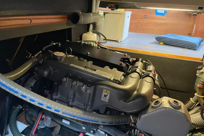 Slide: The Image of Engine compartment of a 2017 Beneteau Sense 50 yacht, showcasing detailed mechanical components. - 31
