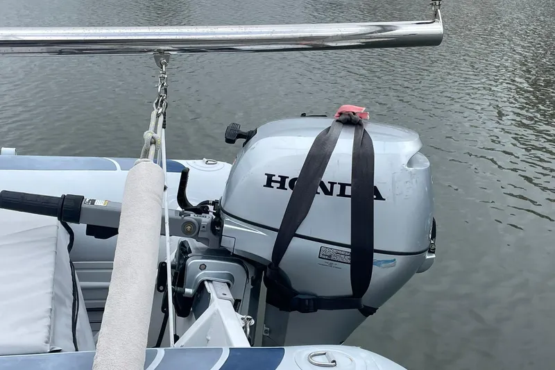 Slide: The Image of Honda outboard motor on a 2017 Beneteau Sense 50 yacht, docked on calm water. - 33