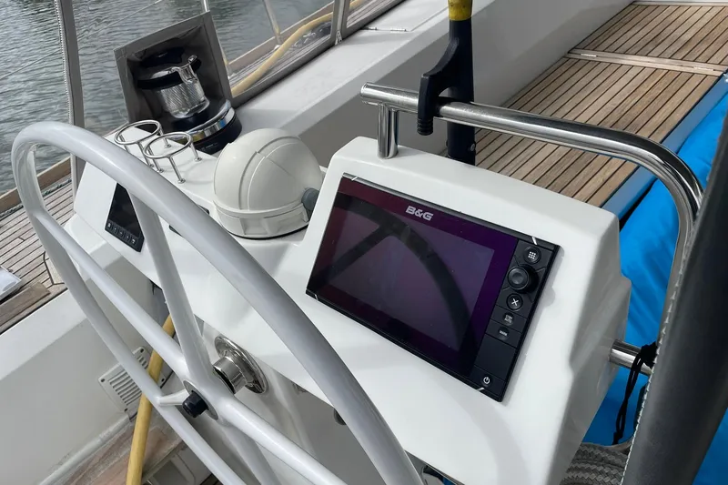 Slide: The Image of Cockpit of 2017 Beneteau Sense 50 yacht with navigation equipment and steering wheel. - 38