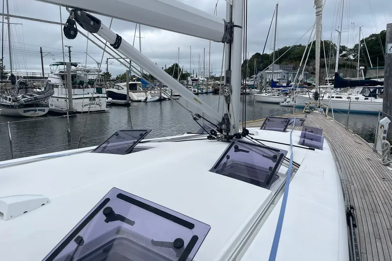Slide: The Image of 2017 Beneteau Sense 50 sailboat docked in a marina, showcasing deck and hatches. - 42