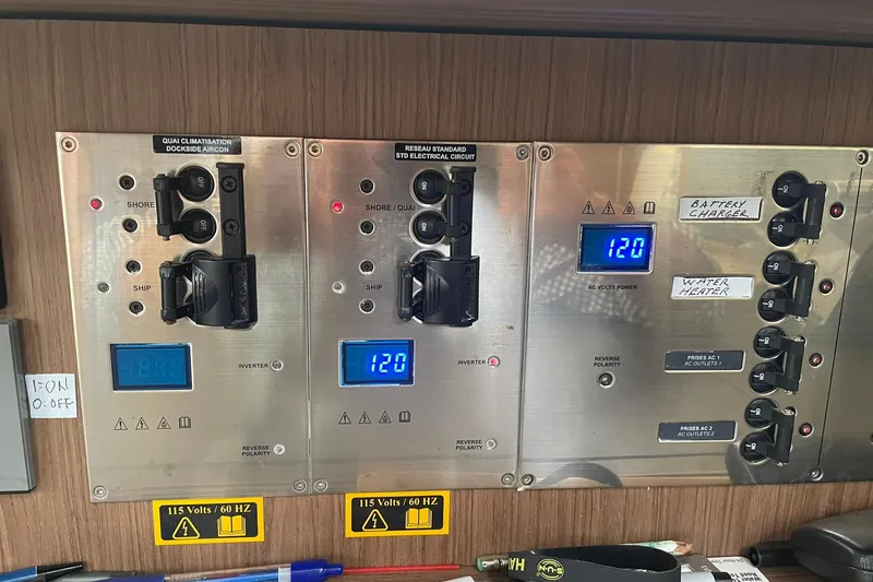 Slide: The Image of Electrical control panel on a 2017 Beneteau Sense 50 yacht, displaying voltage and switches. - 43