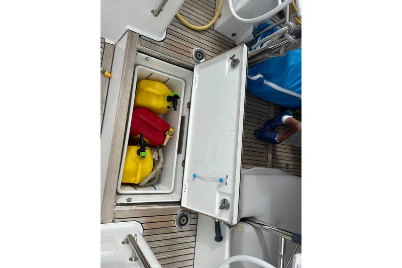 Slide: The Image of Open storage compartment on 2017 Beneteau Sense 50 yacht with fuel containers and rope. - 50