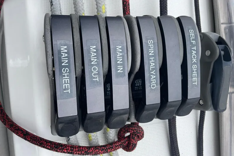 Slide: The Image of Beneteau Sense 50 sailboat control lines labeled: Main Sheet, Main Out, Main In, Spin Halyard, Self Tack Sheet. - 53