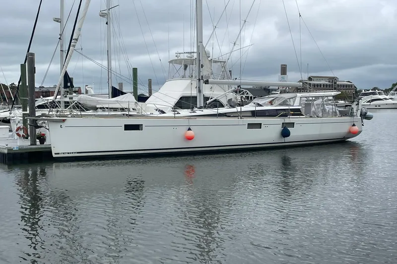 Slide: The Image of 2017 Beneteau Sense 50 yacht docked in a marina, overcast sky. - 54