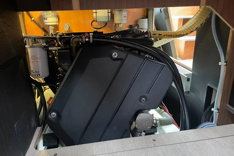 Slide: The Image of Engine compartment of a 2017 Beneteau Sense 50 sailboat, showcasing mechanical components. - 55