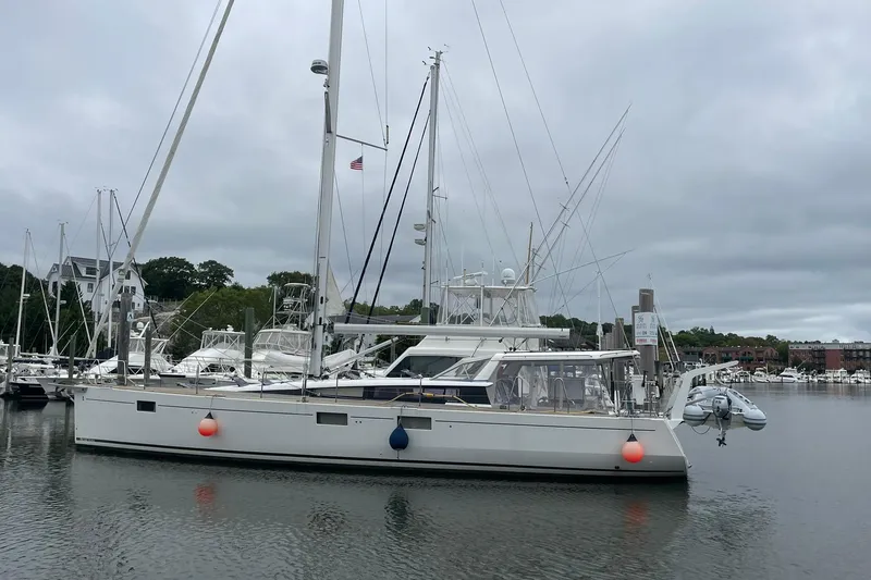 Slide: The Image of 2017 Beneteau Sense 50 yacht docked in a marina under cloudy skies. - 57
