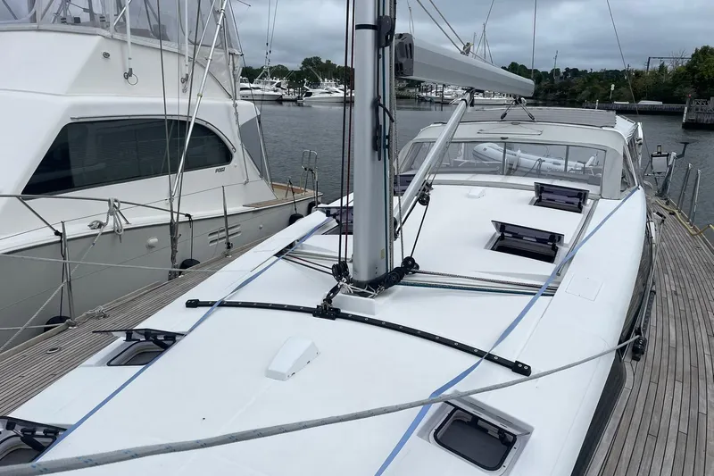 Slide: The Image of 2017 Beneteau Sense 50 yacht docked at marina, showcasing sleek deck design. - 6