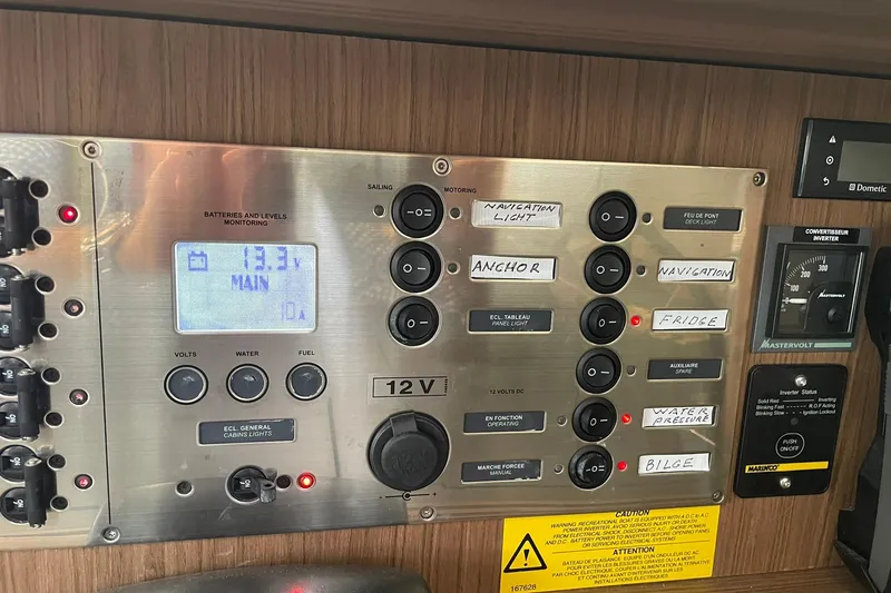 Slide: The Image of Electrical control panel of a 2017 Beneteau Sense 50 yacht with labeled switches. - 60