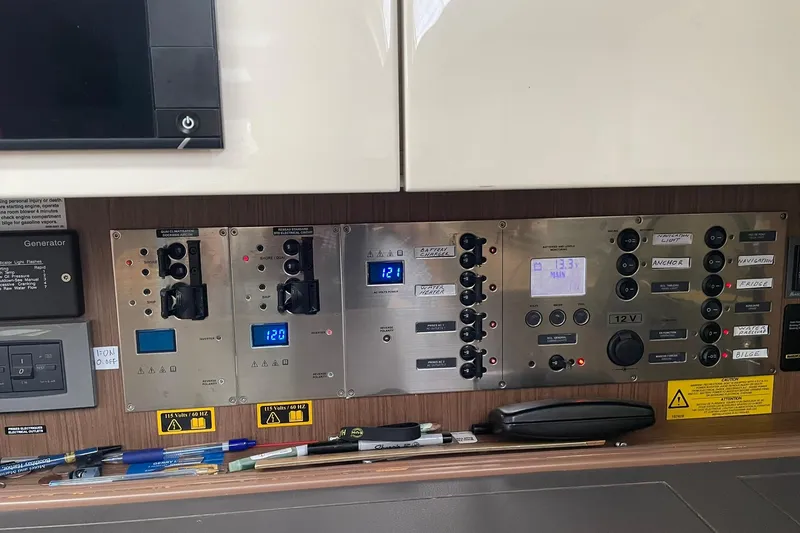 Slide: The Image of Control panel of a 2017 Beneteau Sense 50 yacht with various switches and displays. - 67