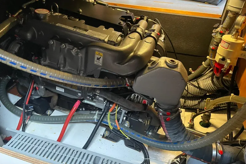 Slide: The Image of Engine compartment of a 2017 Beneteau Sense 50 yacht, showcasing detailed mechanical components. - 68