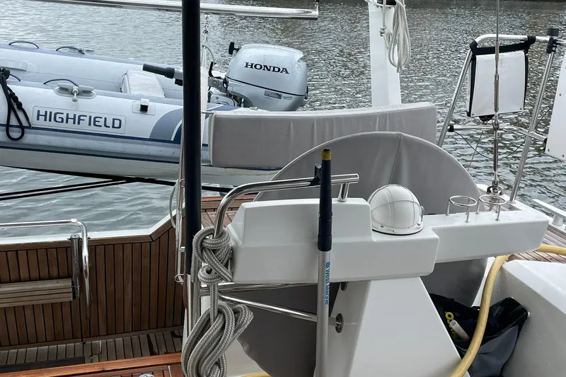 Slide: The Image of Cockpit of 2017 Beneteau Sense 57 yacht with Highfield dinghy and Honda motor. - 88