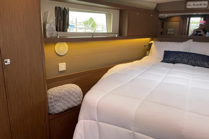 Slide: The Image of Luxurious cabin interior of 2017 Beneteau Sense 57 yacht with cozy bedding and elegant wood finish. - 89