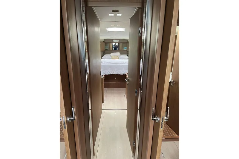 Slide: The Image of Interior view of 2017 Beneteau Sense 50 yacht cabin with wooden finishes. - 9