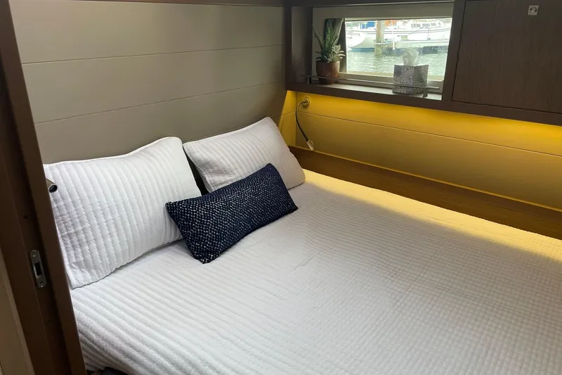 Slide: The Image of Cozy cabin interior of 2017 Beneteau Sense 57 yacht with bed and window view. - 90