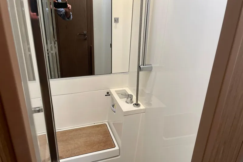 Slide: The Image of Shower area in 2017 Beneteau Sense 57 yacht, featuring modern fixtures and wooden accents. - 91