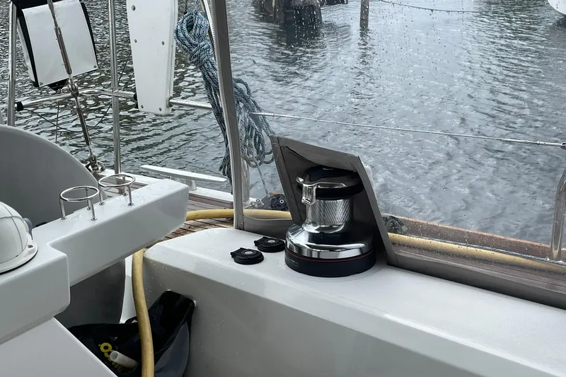 Slide: The Image of Cockpit view of a 2017 Beneteau Sense 57 yacht, featuring winch and water backdrop. - 92