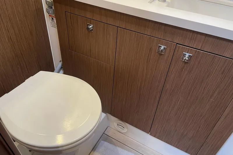 Slide: The Image of Bathroom interior of 2017 Beneteau Sense 57 yacht with wooden cabinetry. - 93