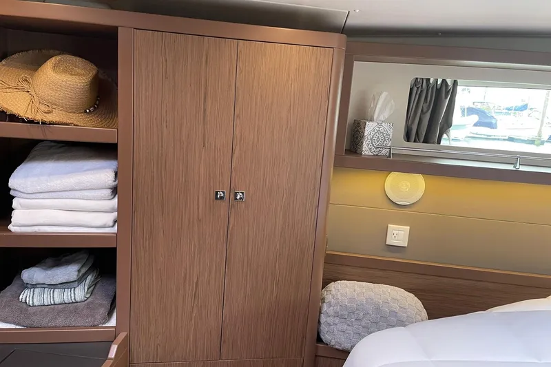 Slide: The Image of Cozy interior of 2017 Beneteau Sense 57 yacht with wooden cabinetry and soft furnishings. - 97