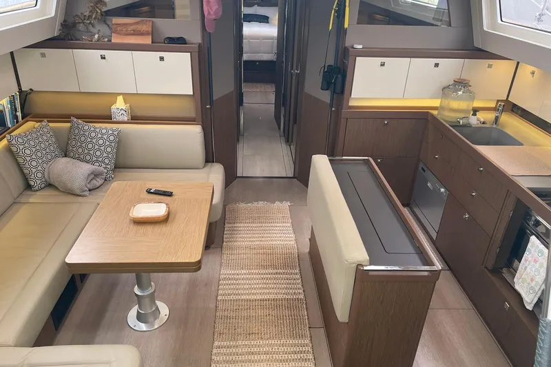 Slide: The Image of Luxurious interior of a 2017 Beneteau Sense 57 yacht with modern kitchen and seating area. - 98