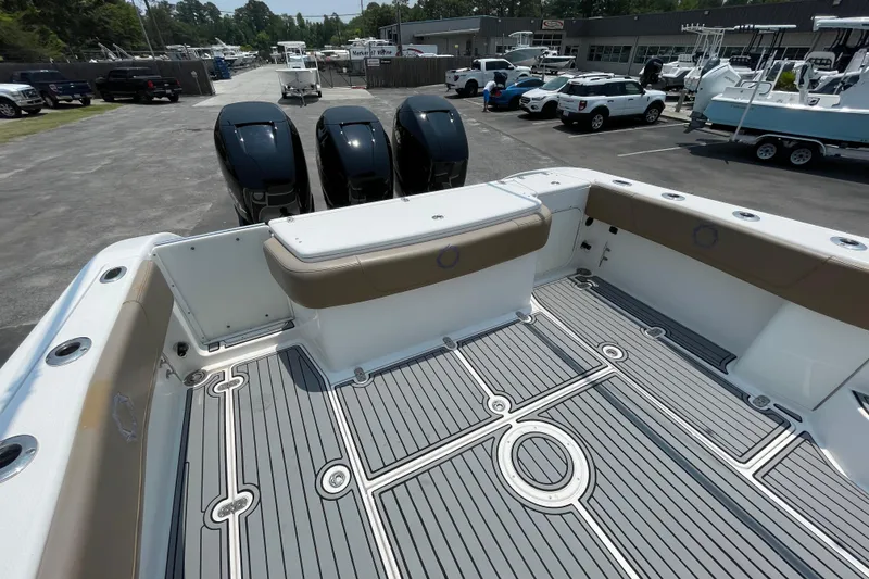 Slide: The Image of 2007 Fountain 38 Sportfish Cruiser OB with triple outboard engines, docked at a marina. - 10