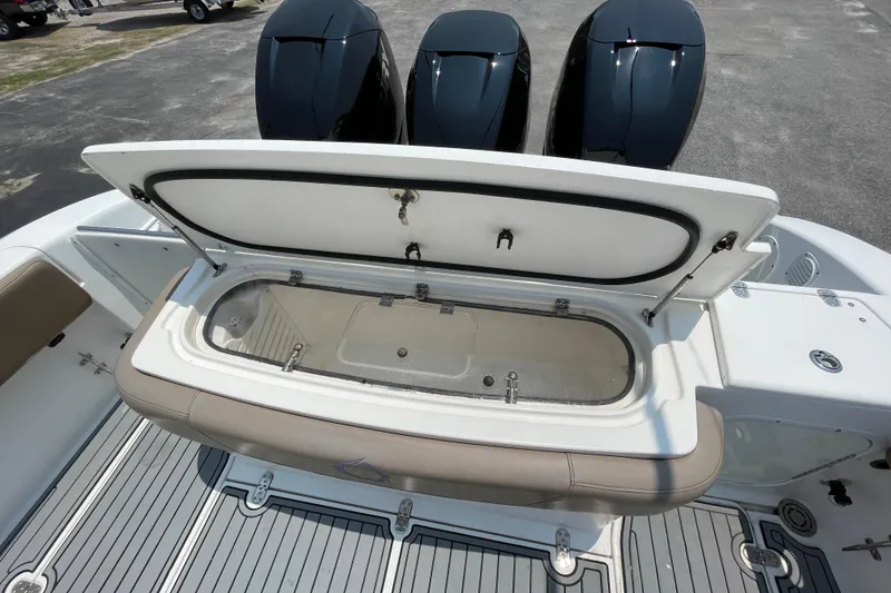 Slide: The Image of 2007 Fountain 38 Sportfish Cruiser OB with open storage compartment and triple outboard engines. - 14