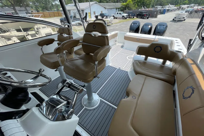Slide: The Image of 2007 Fountain 38 Sportfish Cruiser OB interior with tan seating and modern controls. - 21