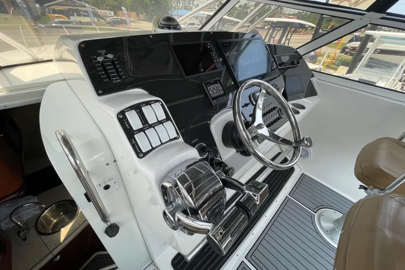 Slide: The Image of 2007 Fountain 38 Sportfish Cruiser OB helm with modern controls and navigation equipment. - 22