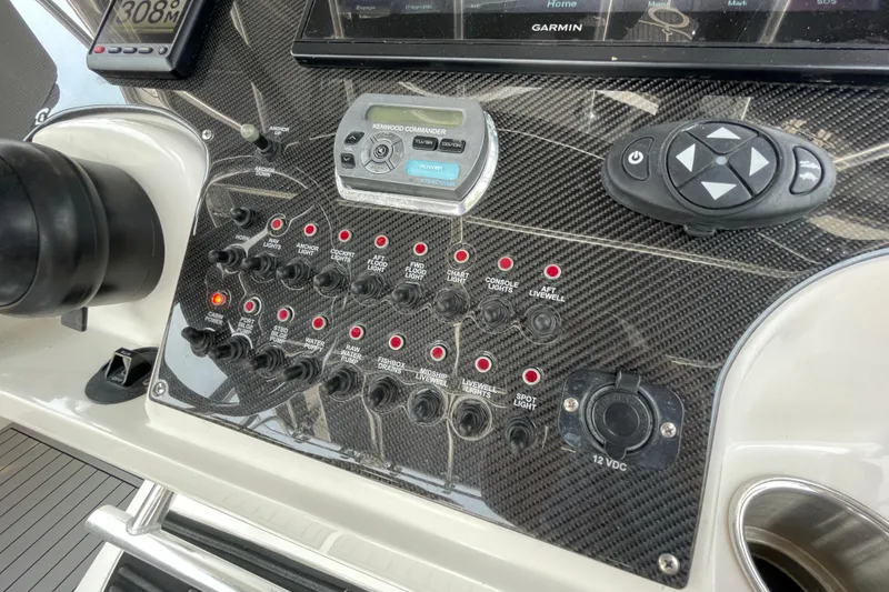 Slide: The Image of Control panel of 2007 Fountain 38 Sportfish Cruiser OB with switches and navigation equipment. - 24