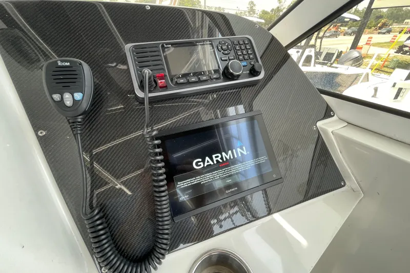 Slide: The Image of 2007 Fountain 38 Sportfish Cruiser OB dashboard with Garmin and Icom devices. - 25