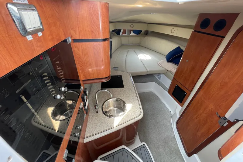 Slide: The Image of 2007 Fountain 38 Sportfish Cruiser OB interior with kitchenette, sink, and cozy seating area. - 28