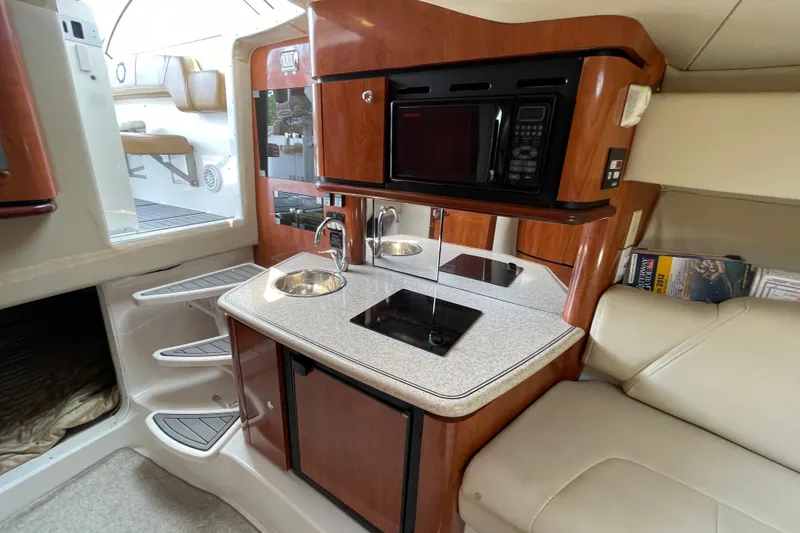 Slide: The Image of 2007 Fountain 38 Sportfish Cruiser OB interior with kitchenette, microwave, and seating area. - 29