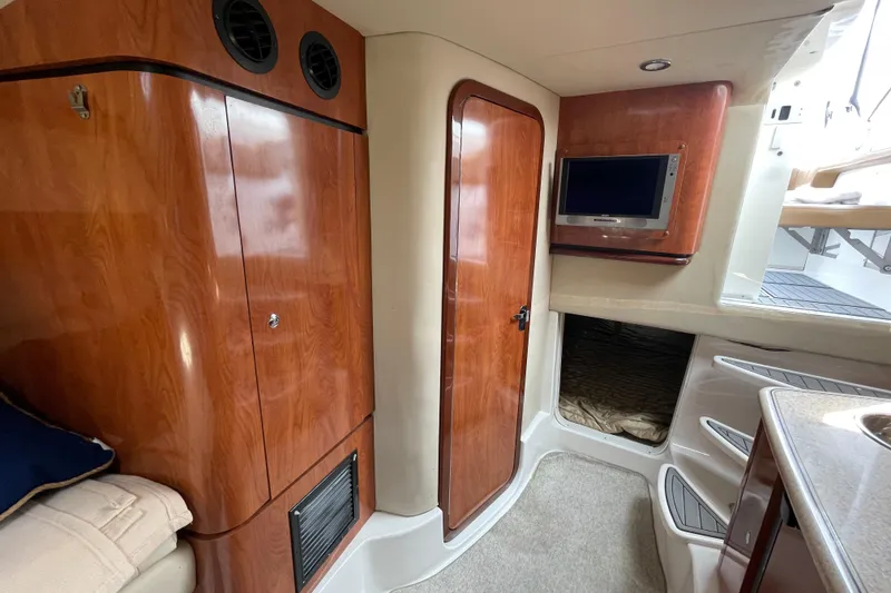 Slide: The Image of 2007 Fountain 38 Sportfish Cruiser OB interior with wood finish, TV, and cozy cabin space. - 30