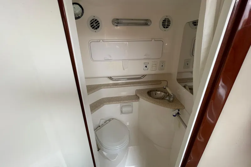 Slide: The Image of 2007 Fountain 38 Sportfish Cruiser OB bathroom with sink, toilet, and storage compartments. - 32