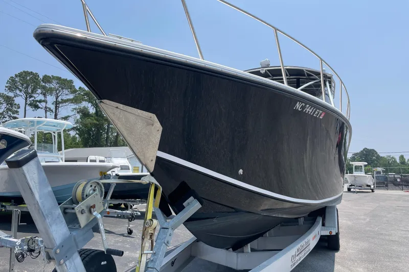 Slide: The Image of 2007 Fountain 38 Sportfish Cruiser OB on trailer, sleek black hull, outdoor setting. - 4